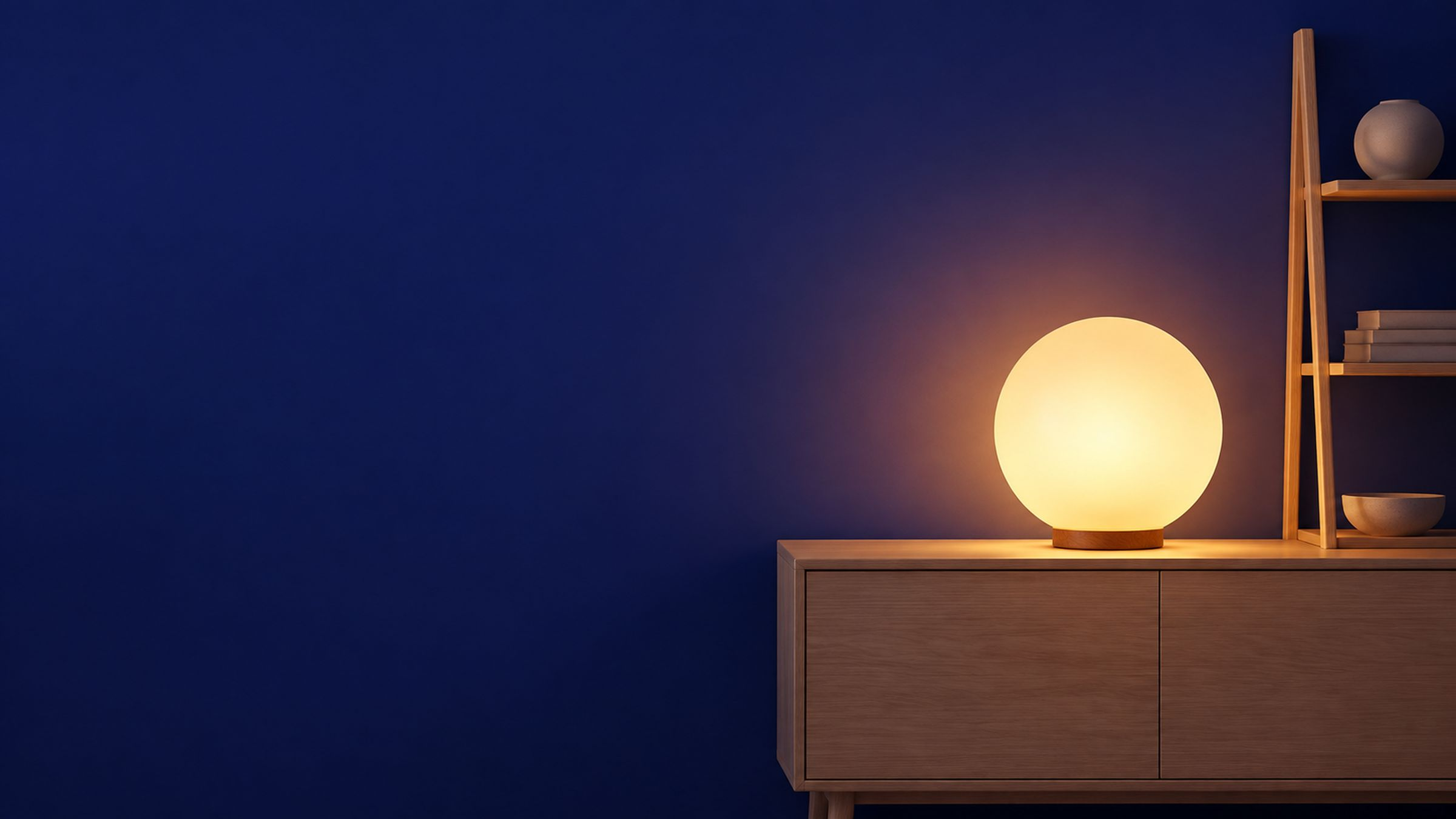 Warm globe lamp on a wooden sideboard against a navy wall